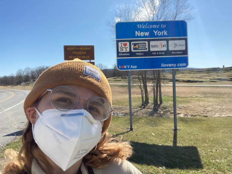 Lindert in front of Welcome to New York sign