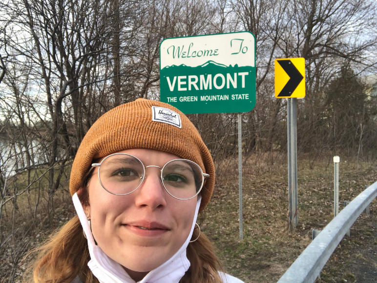 Lindert in front of Welcome to New York sign