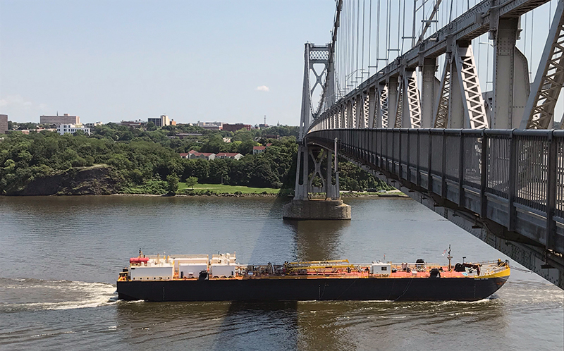 a boat going under a bridge