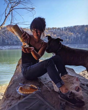 Woman eating pie with dog